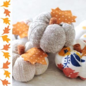 Grey and orange fabric pumpkins on a white table