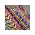 Multicolored friendship bracelets laying on a grey table