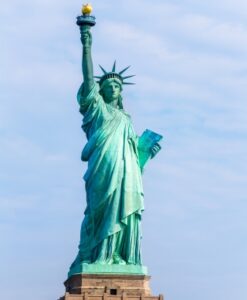 Statue of Liberty set against a blue sky with slight white wispy clouds