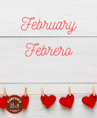 An off white wall with the words February and Febrero on it and cut out hearts put up with clothespins in a row under the words