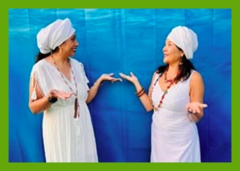 Two women in white dresses and white head coverings looking at each other on a blue watery looking background